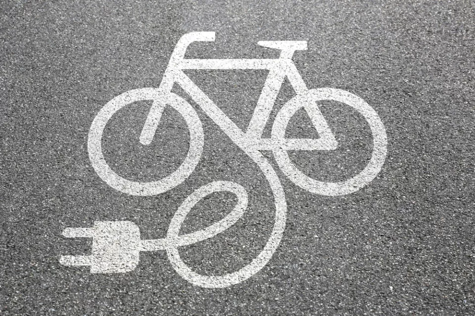 Electric bike charging logo on asphalt